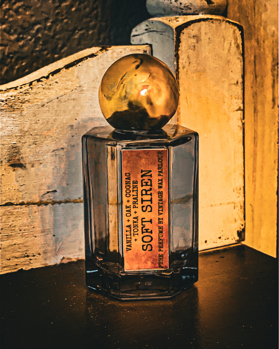 Perfume bottle labeled 'Soft Siren' on a wooden surface