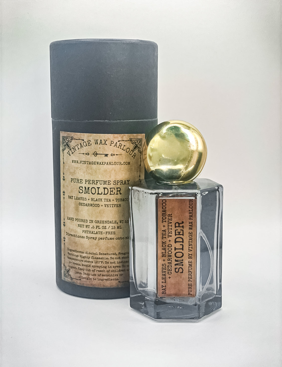 Perfume bottle labeled 'Smolder' with a cylindrical container on a white background