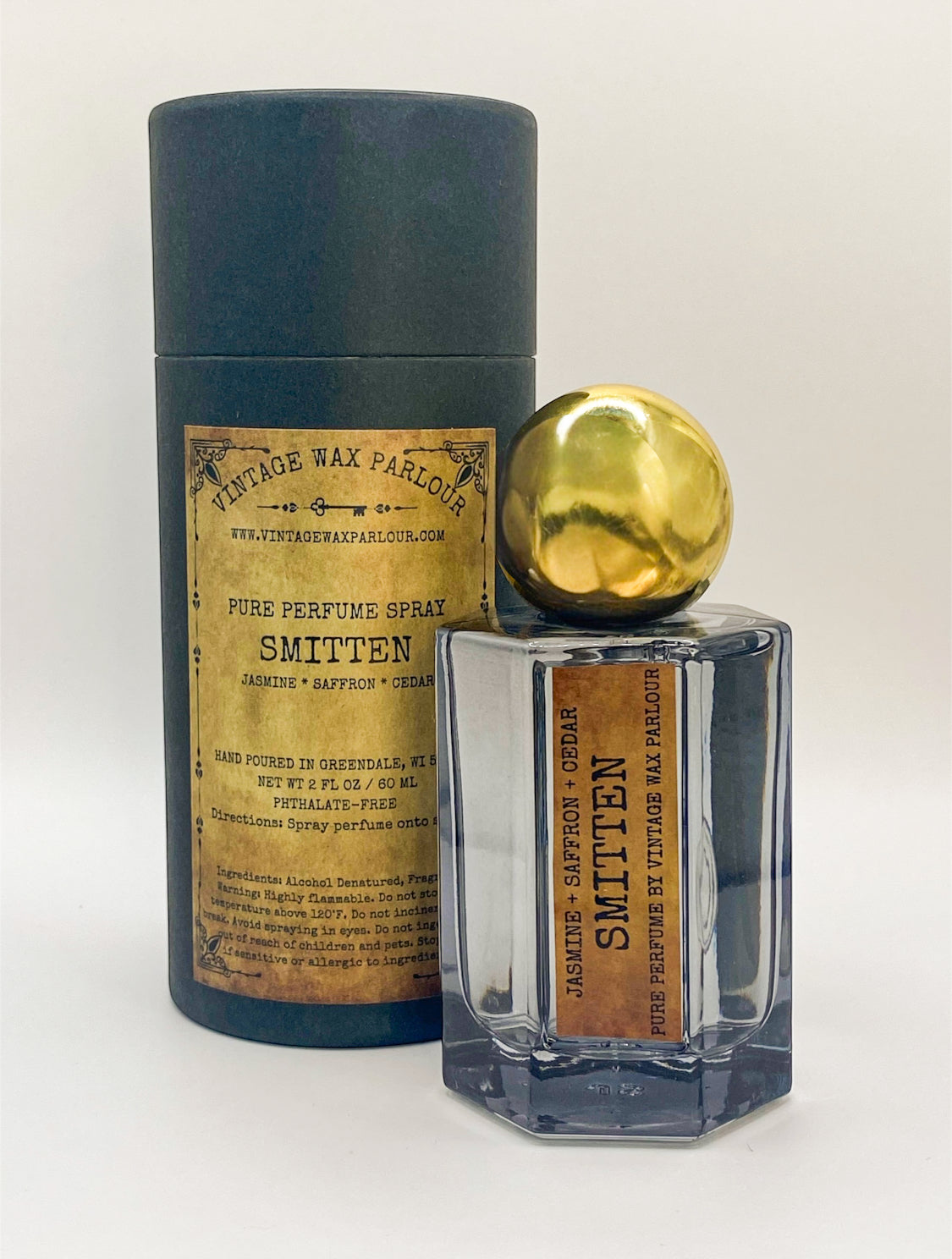 Perfume bottle with wooden cap and decorative label on a white background
