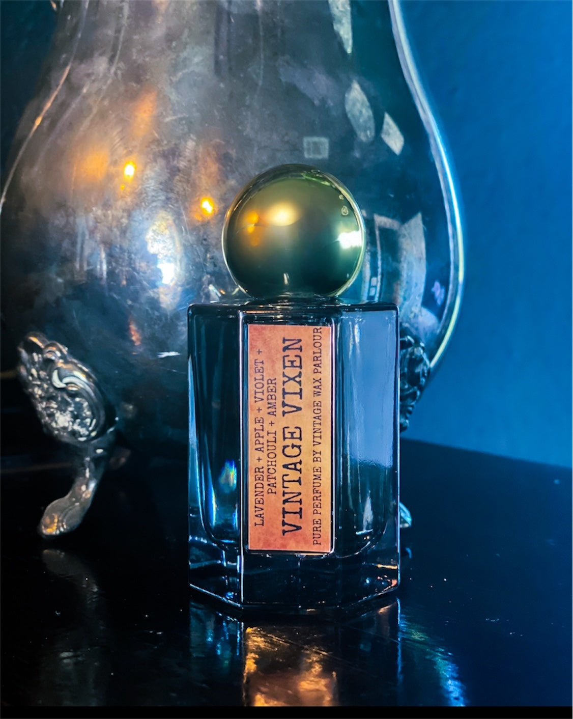 Perfume bottle with a vintage design on a reflective surface