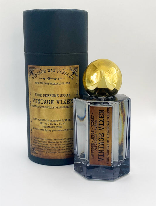 Perfume bottle with gold cap and 'Vintage Vixen' label on a white background