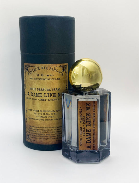 Perfume bottle with gold cap and decorative label on a white background