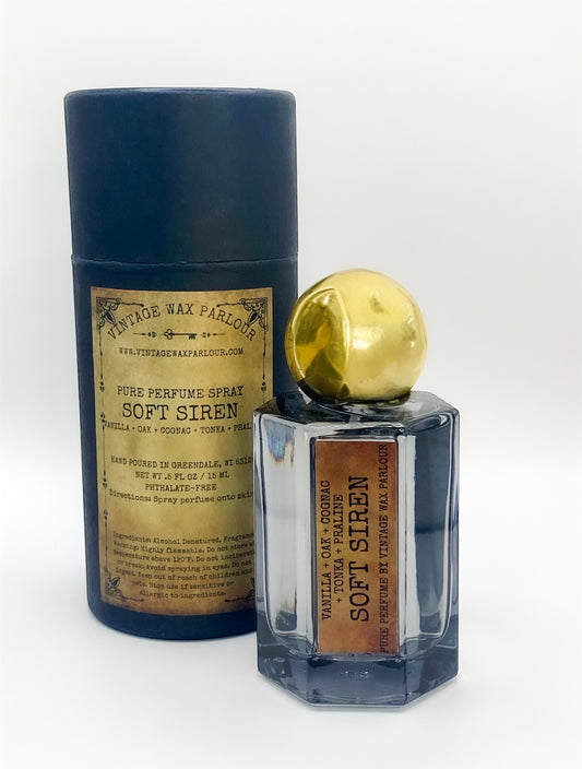 Perfume bottle with gold cap and vintage-style label on a white background