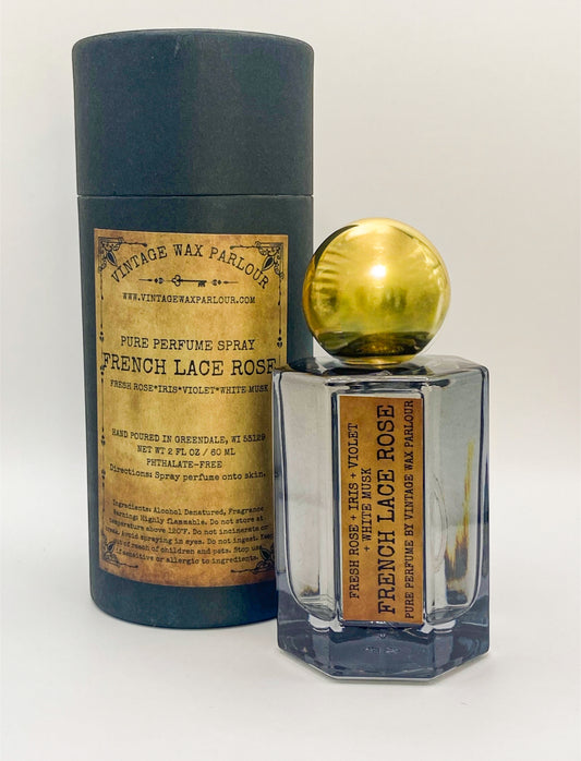 Perfume bottle with gold cap and vintage-style label on a white background