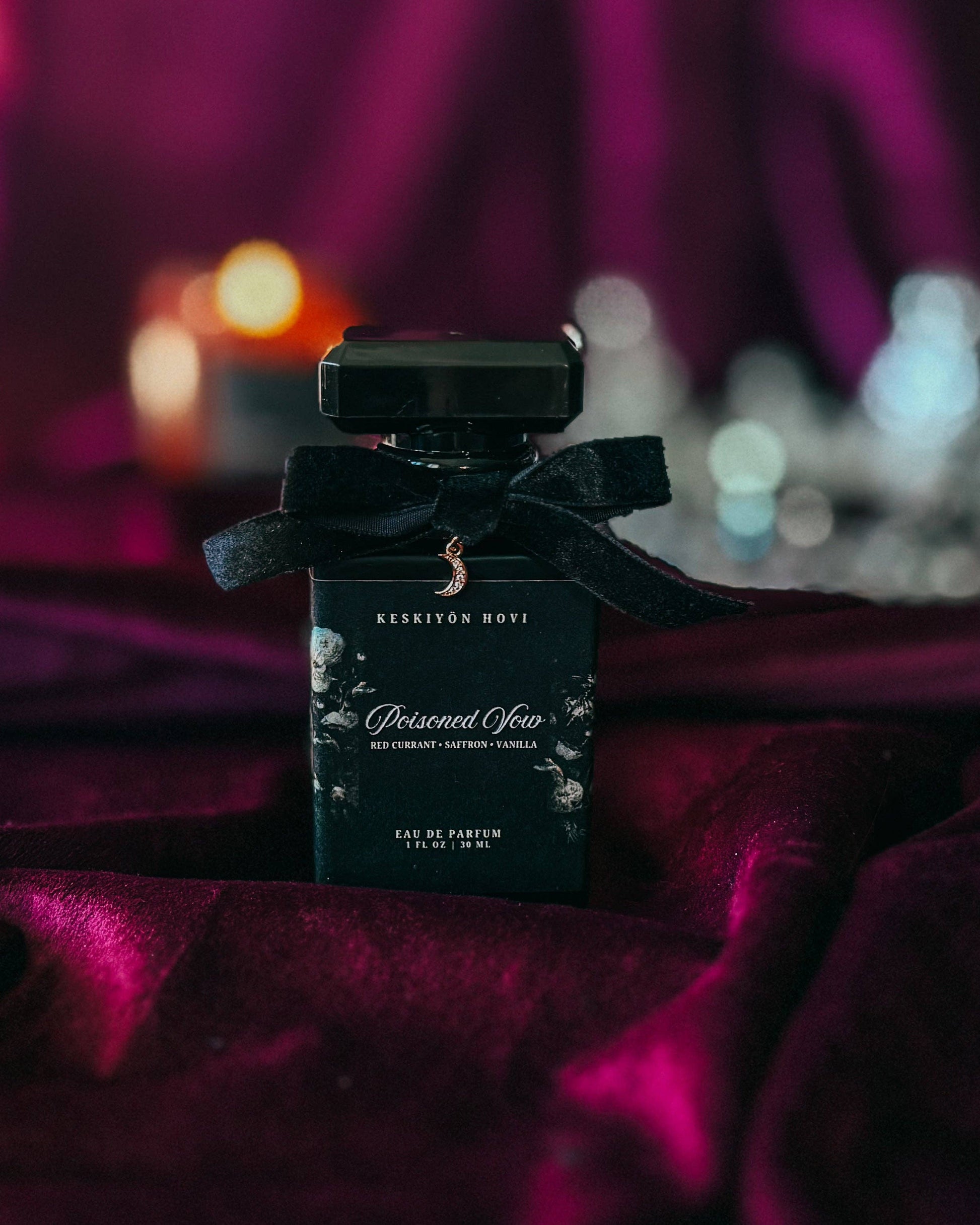 Perfume bottle with black bow on a dark background
