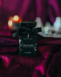 Perfume bottle with black bow on a dark background